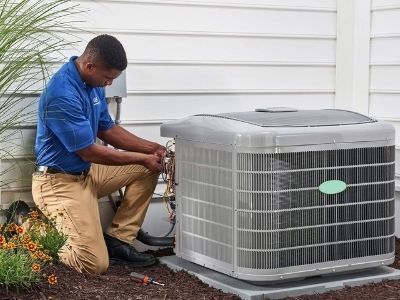 Checking Outdoor Unit — Portage, MI — Dan Wood Company Checking Outdoor Unit — Portage, MI — Dan Wood Company