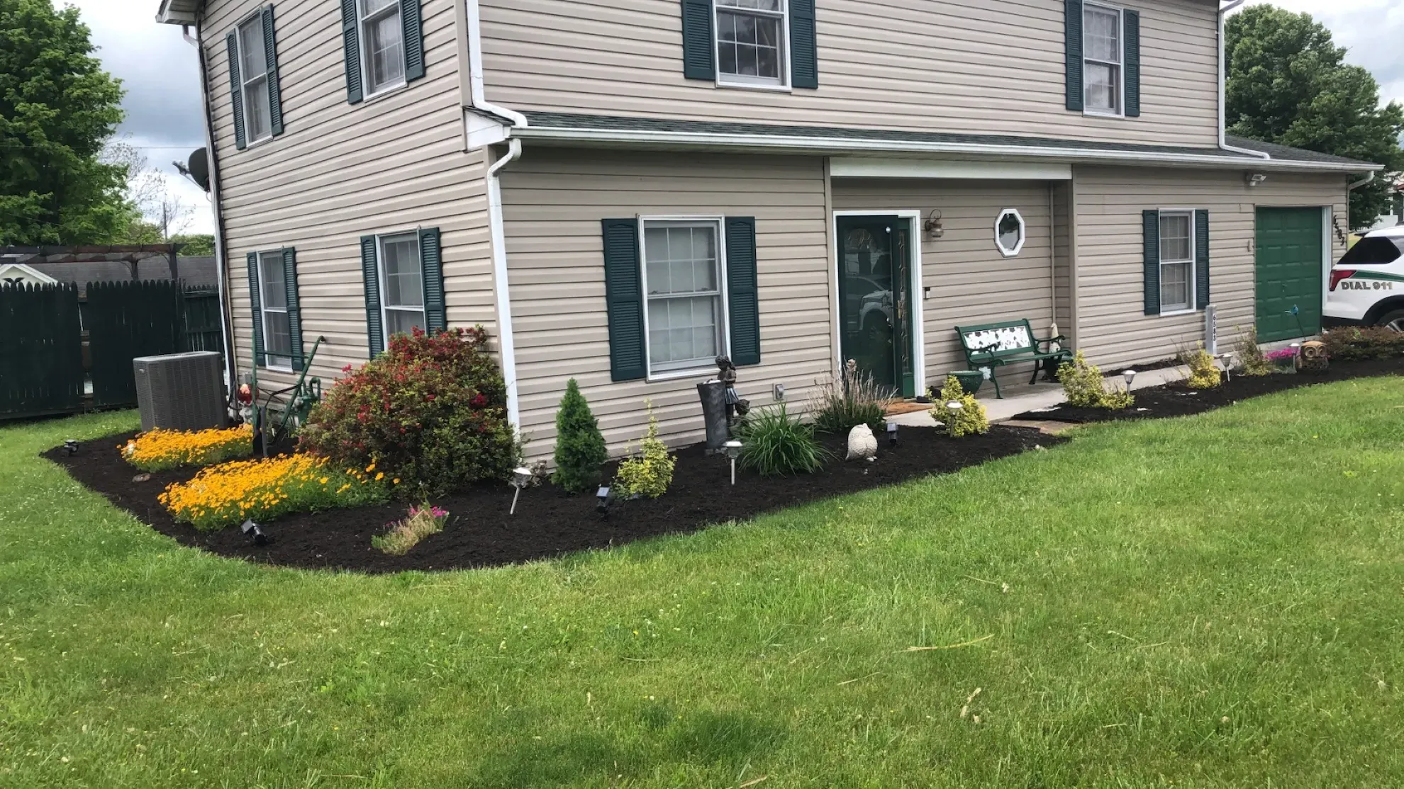 A large house with a lush green lawn in front of it.