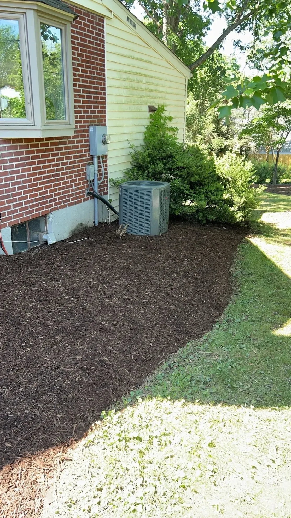 A house with a air conditioner on the side of it.