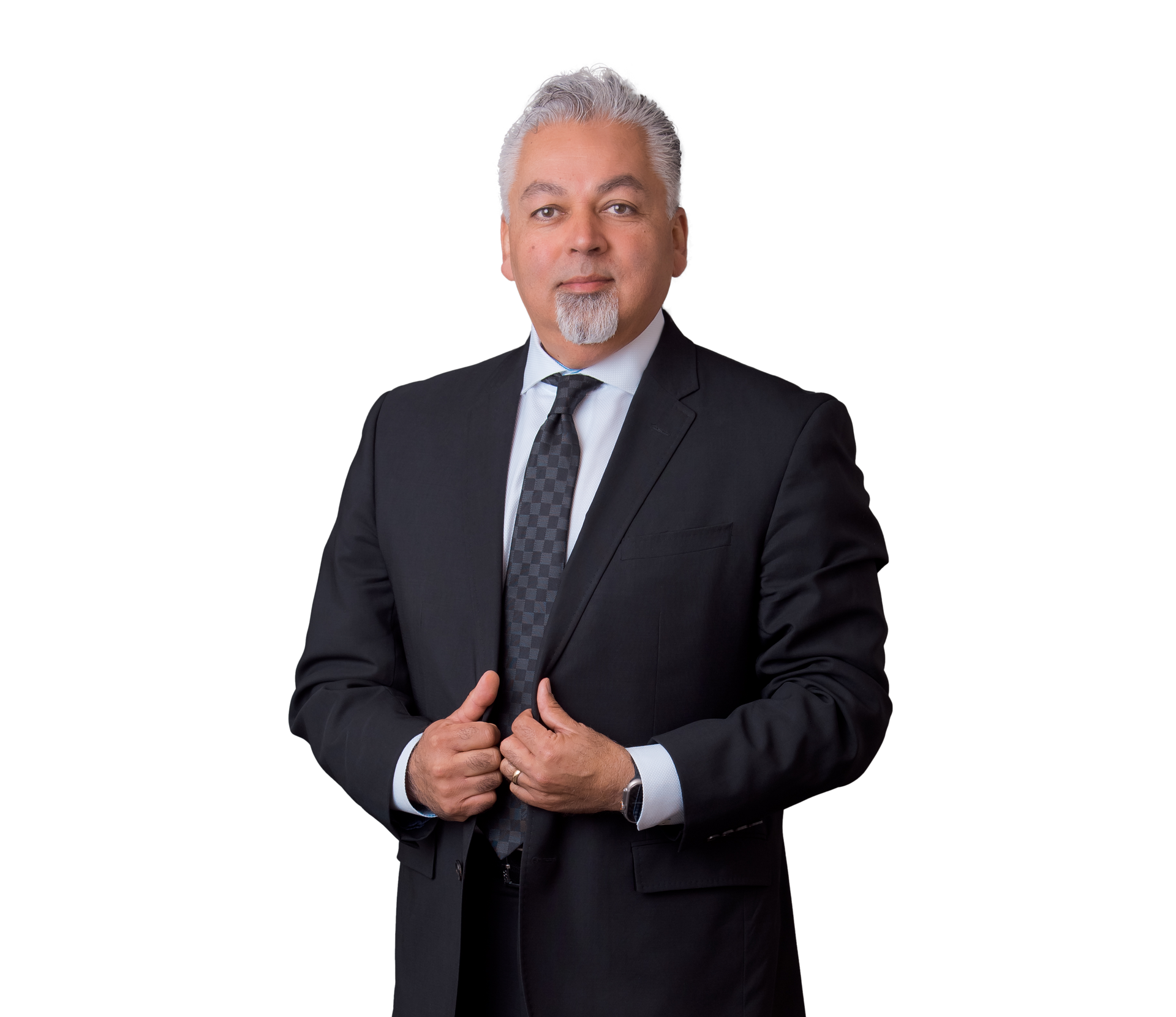 Man in a black suit and tie standing against a white background, adjusting his jacket