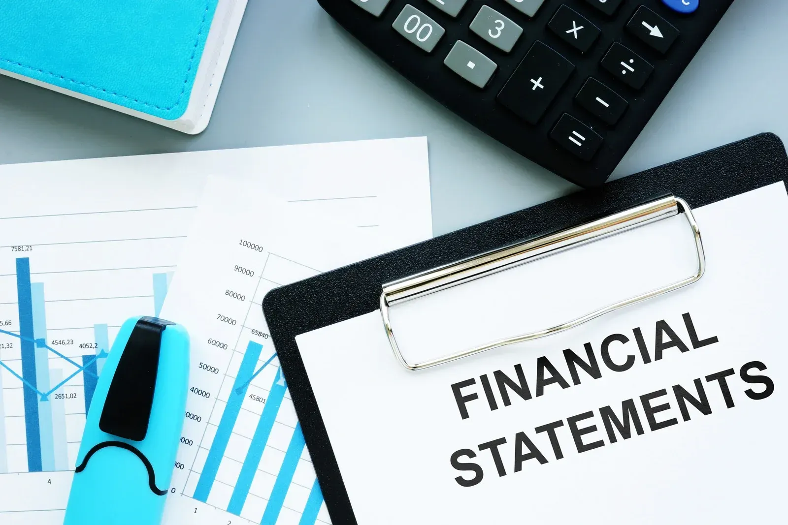 A clipboard with the word financial statements written on it