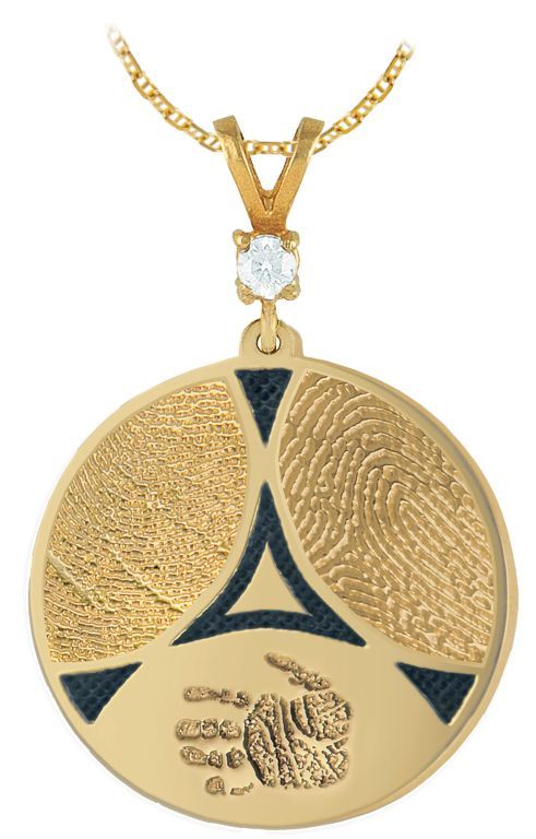 Gold circular pendant necklace with engraved patterns and a small clear stone accent