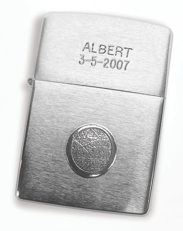 Silver Zippo lighter engraved “ALBERT 3-5-2007” with a circular emblem on the front