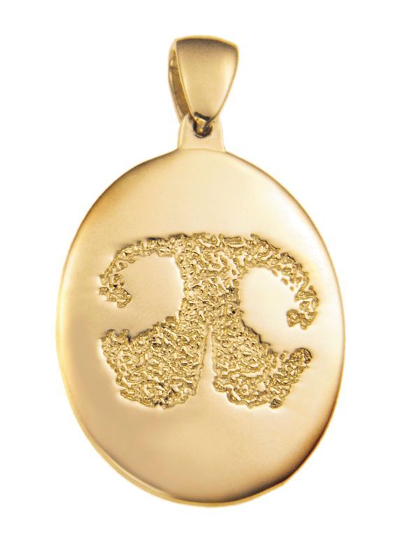 Gold oval pendant with a textured zodiac Gemini symbol on a plain background