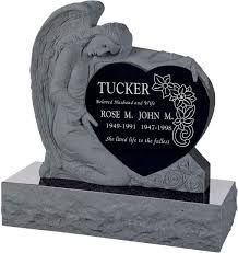 Gray sculpted headstone with engraved black plaque and base for Tucker memorializing Rose M. John M. ￼