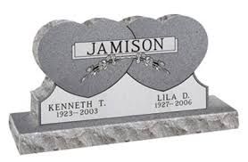 Double-heart gravestone engraved “Jamison” with the names Kenneth T. and Lila D. on a stone base