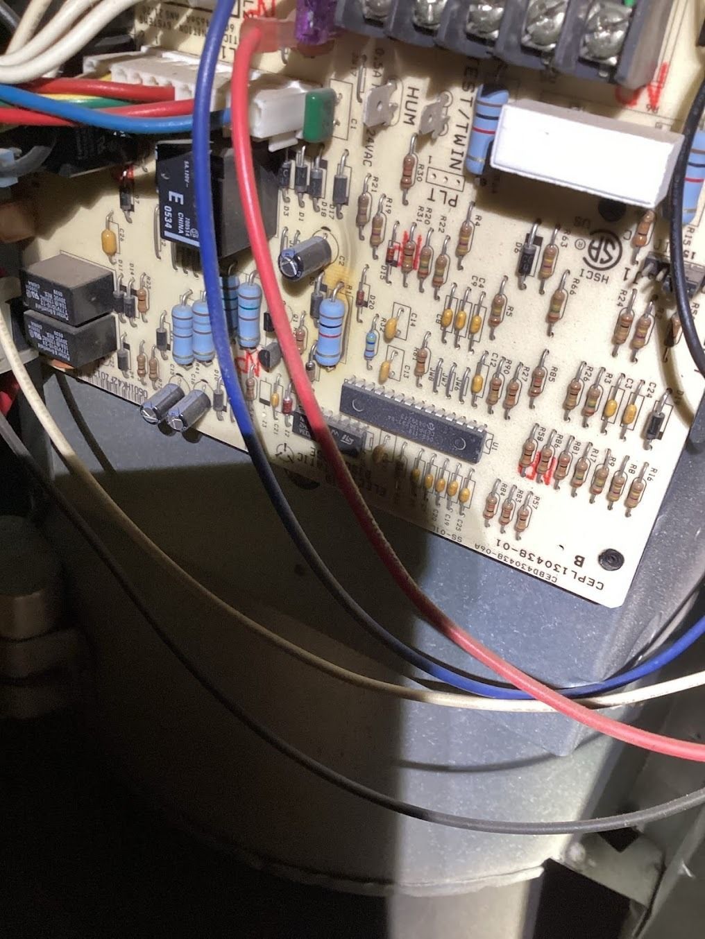 Circuit board with many wires and connectors mounted inside an electrical device.