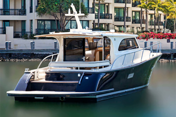 A boat is docked in the water in front of a building.
