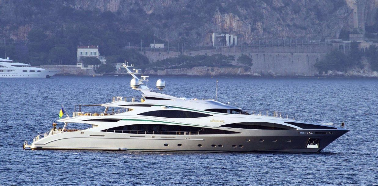 A large yacht is floating on top of a body of water