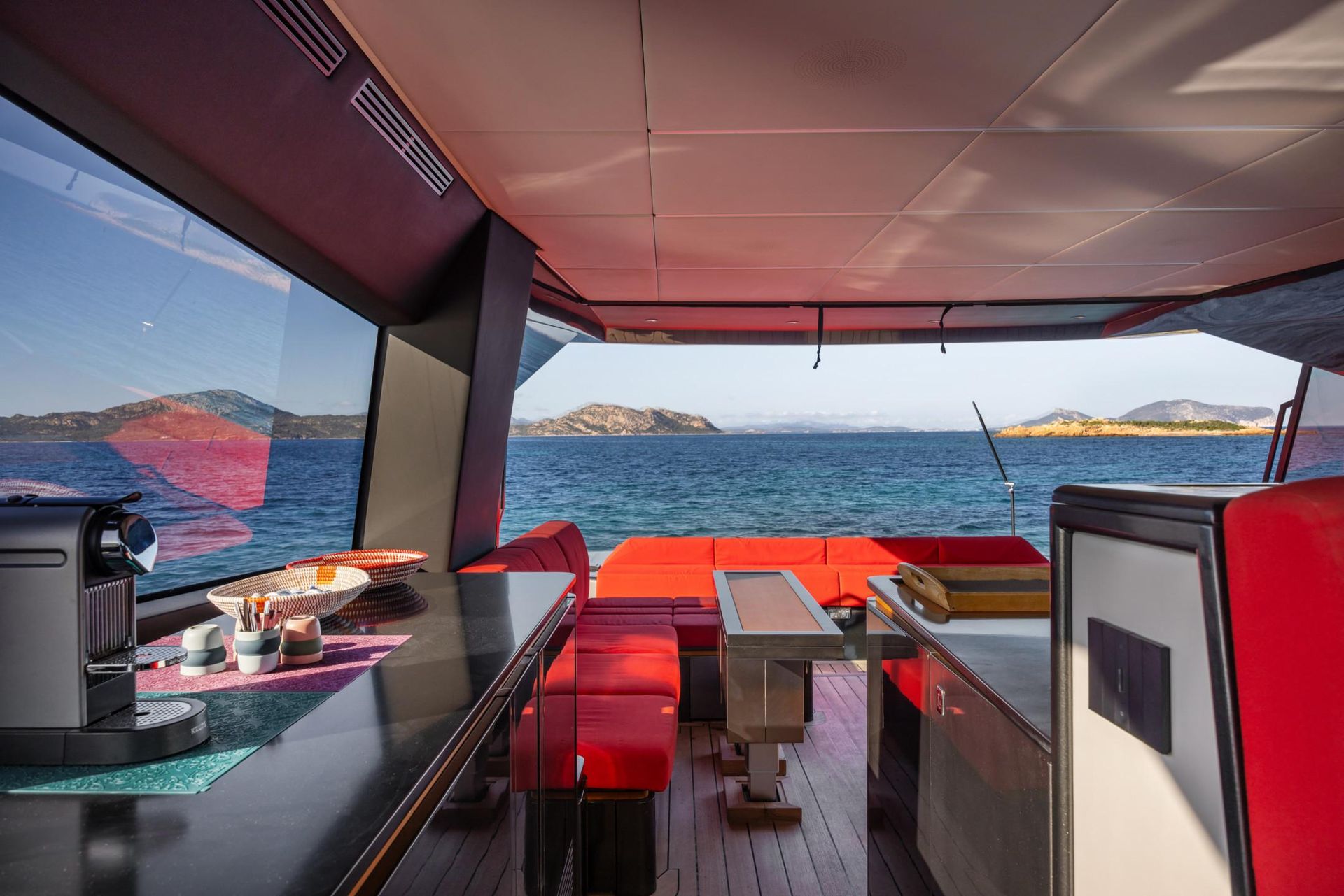 The inside of a boat with a view of the ocean.
