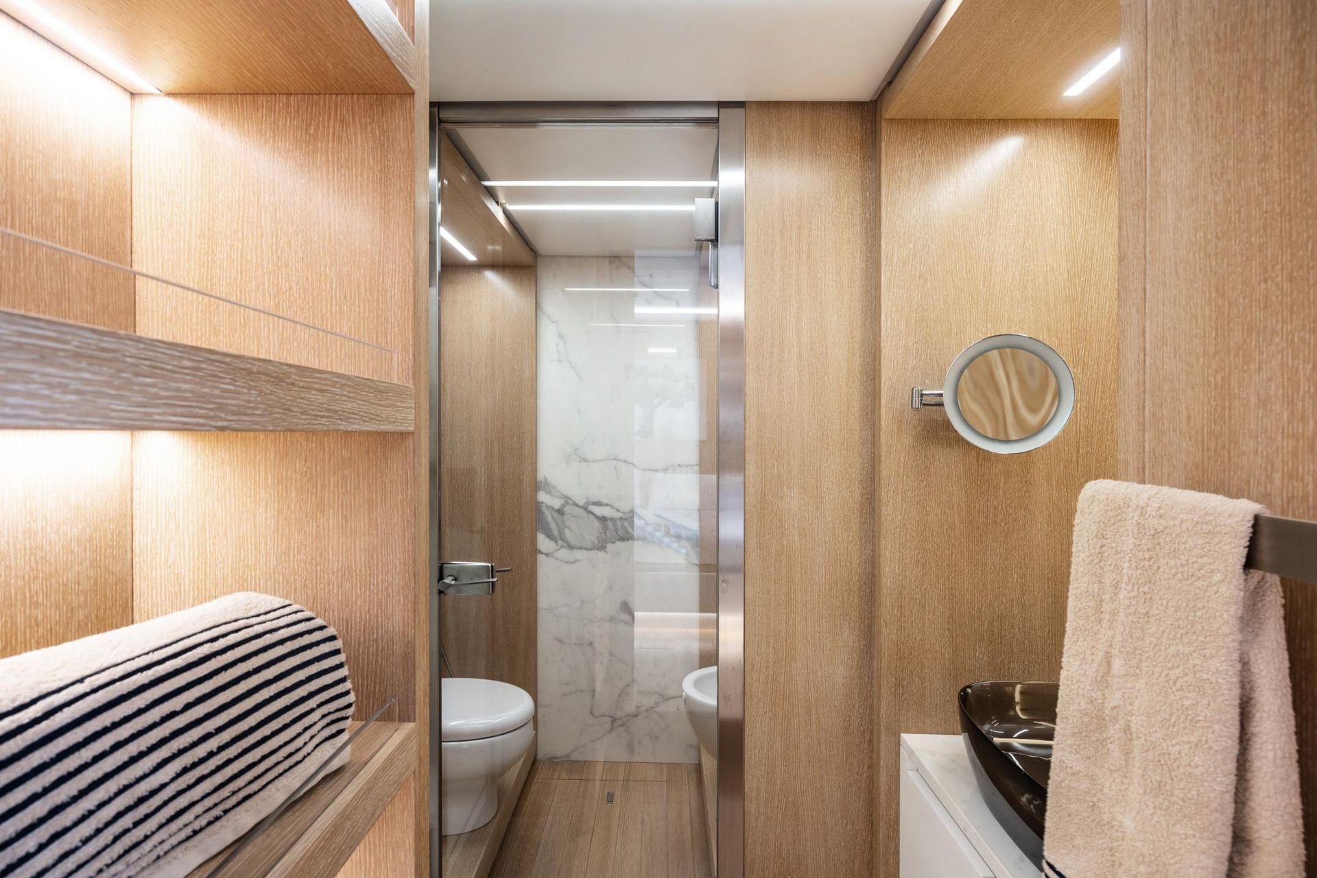 A bathroom with a toilet , sink , mirror and shower.