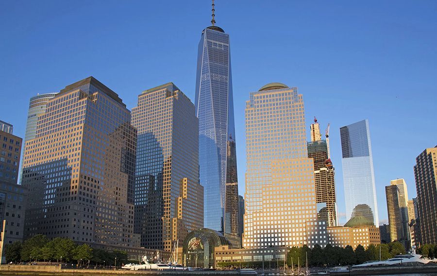 A city skyline with a statue of liberty in the foreground.