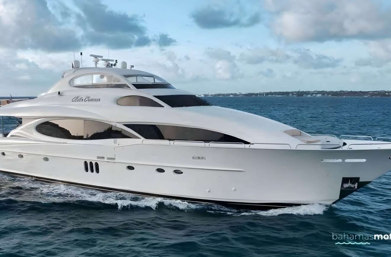 A large white yacht is floating on top of a body of water.