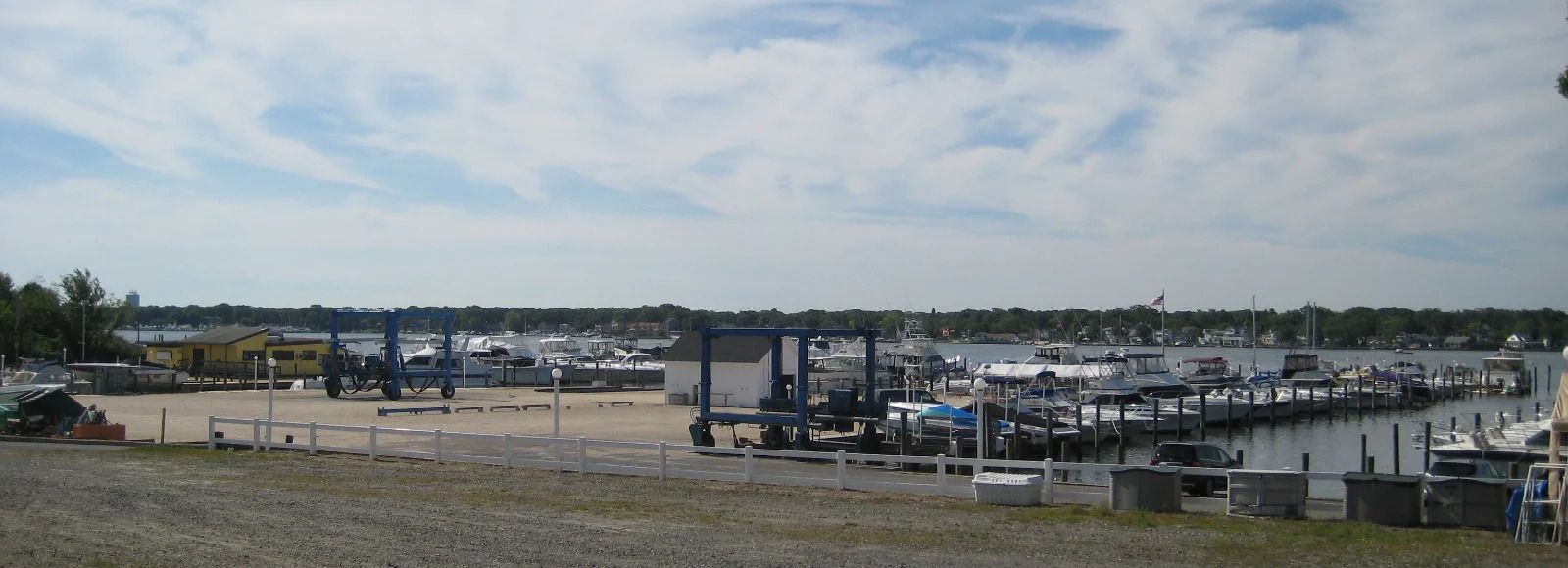 A lot of boats are docked at a marina on a cloudy day