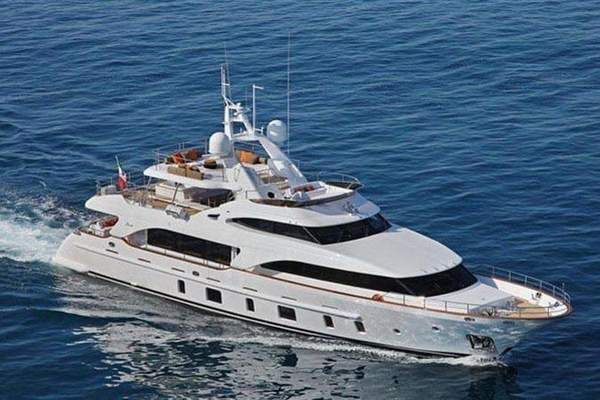 A large white yacht is floating on top of a body of water.