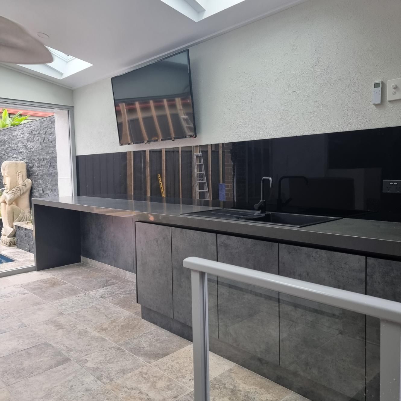 An Outdoor Kitchen With A Mini Fridge and Sink — Darko's Kitchens in Albion Park Rail, NSW