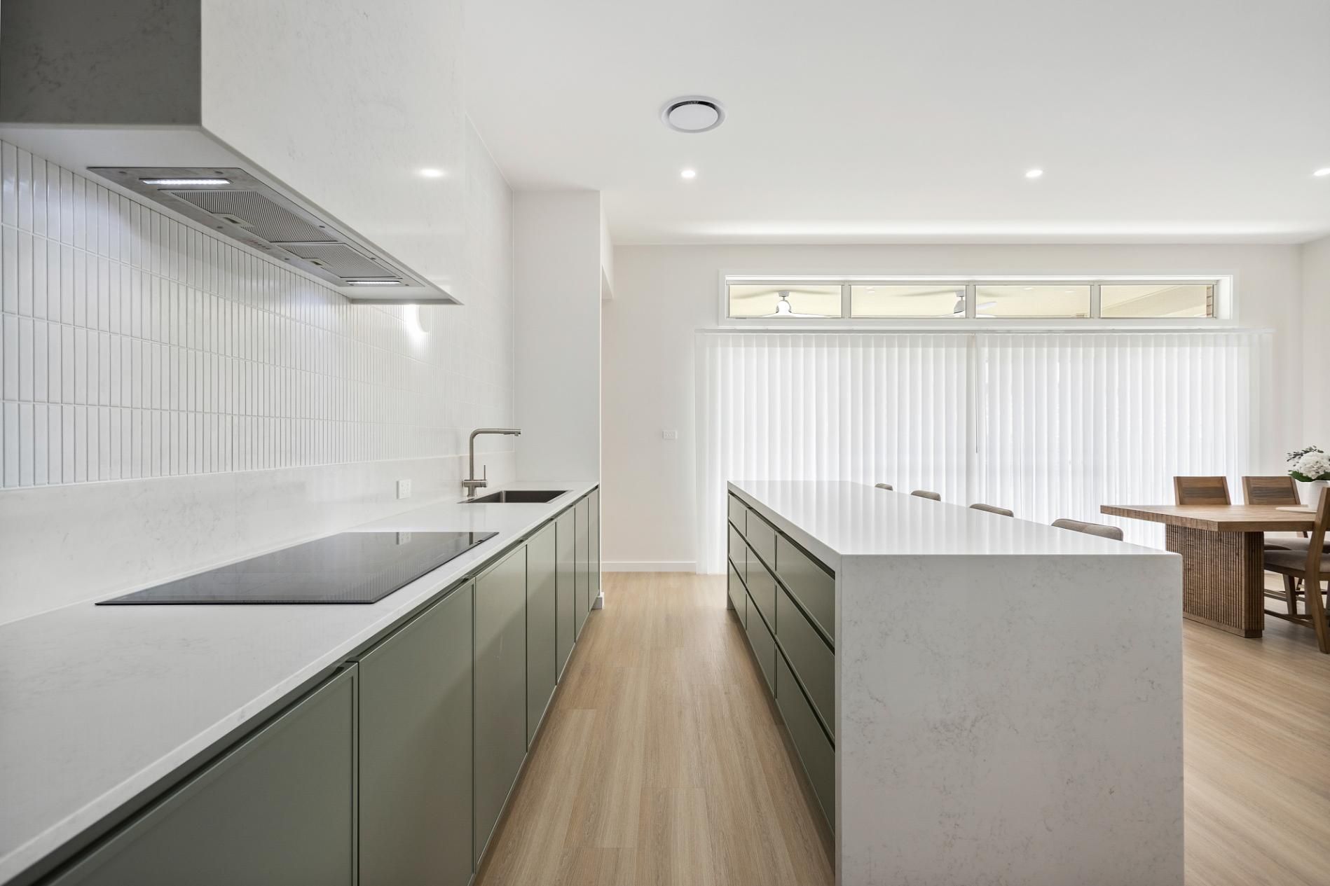 A Kitchen With White benches, Green cupboards, and a Large Island — Darko's Kitchens in Albion Park Rail, NSW