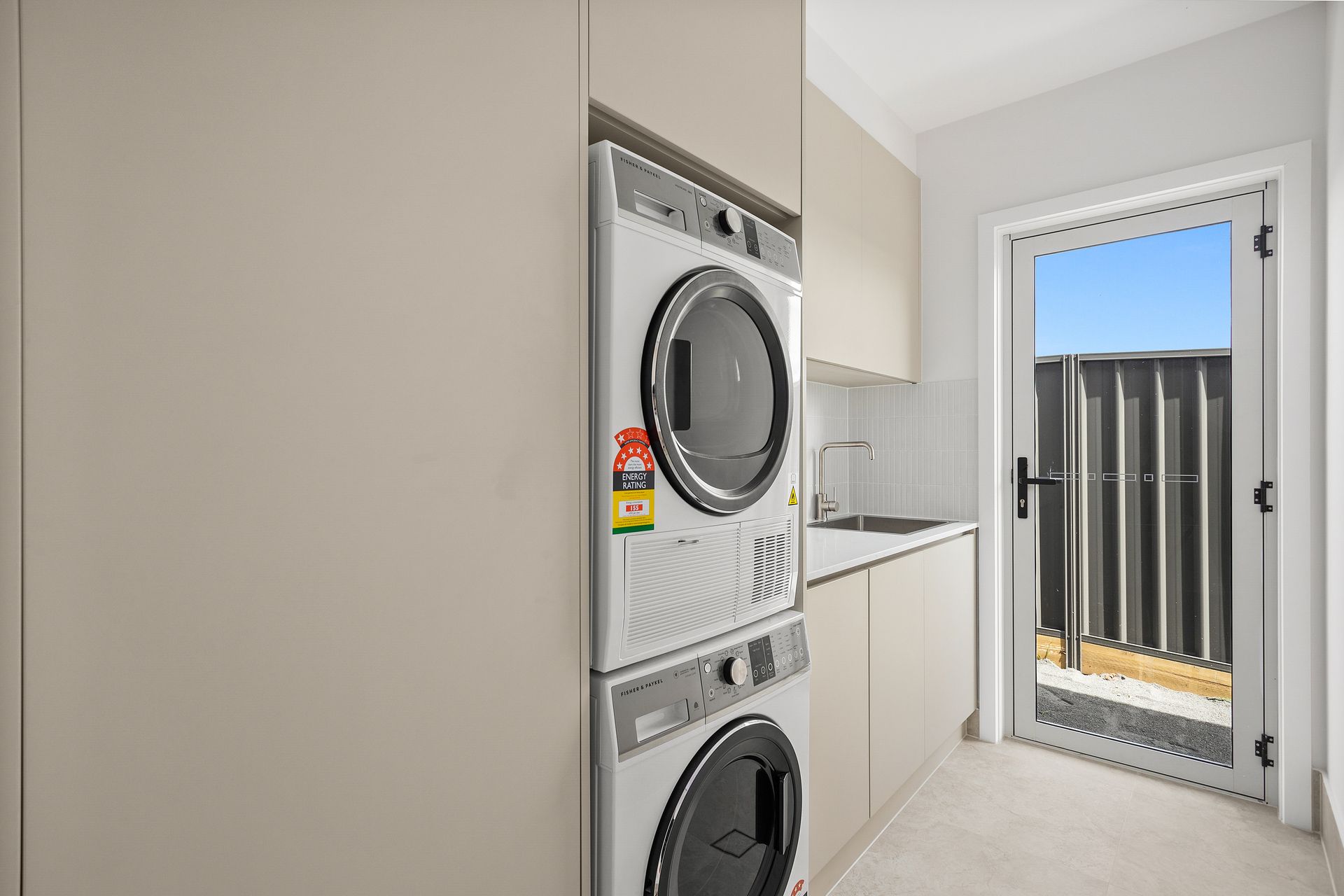 A Laundry Room With a Washer and Dryer and a Sink — Darko's Kitchens in Albion Park Rail, NSW