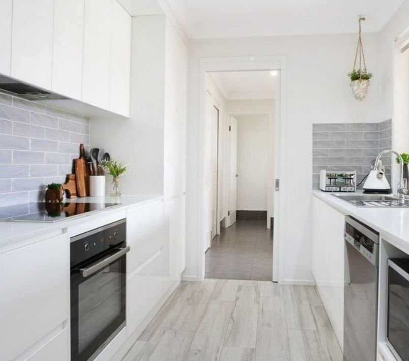 A Kitchen With White Cabinets and Stainless Steel Appliances — Darko's Kitchens in Dapto, NSW