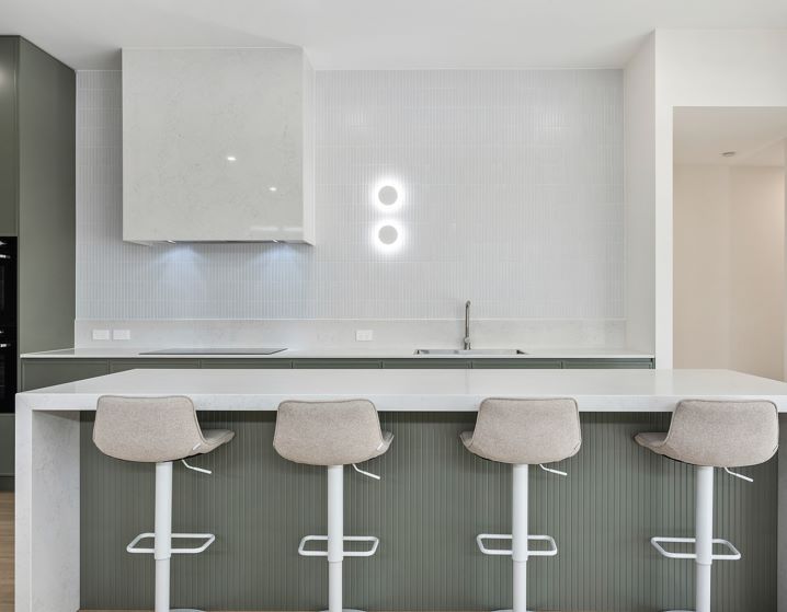 A Kitchen With a Long Island and Four Bar Stools — Darko's Kitchens in Fairy Meadow, NSW