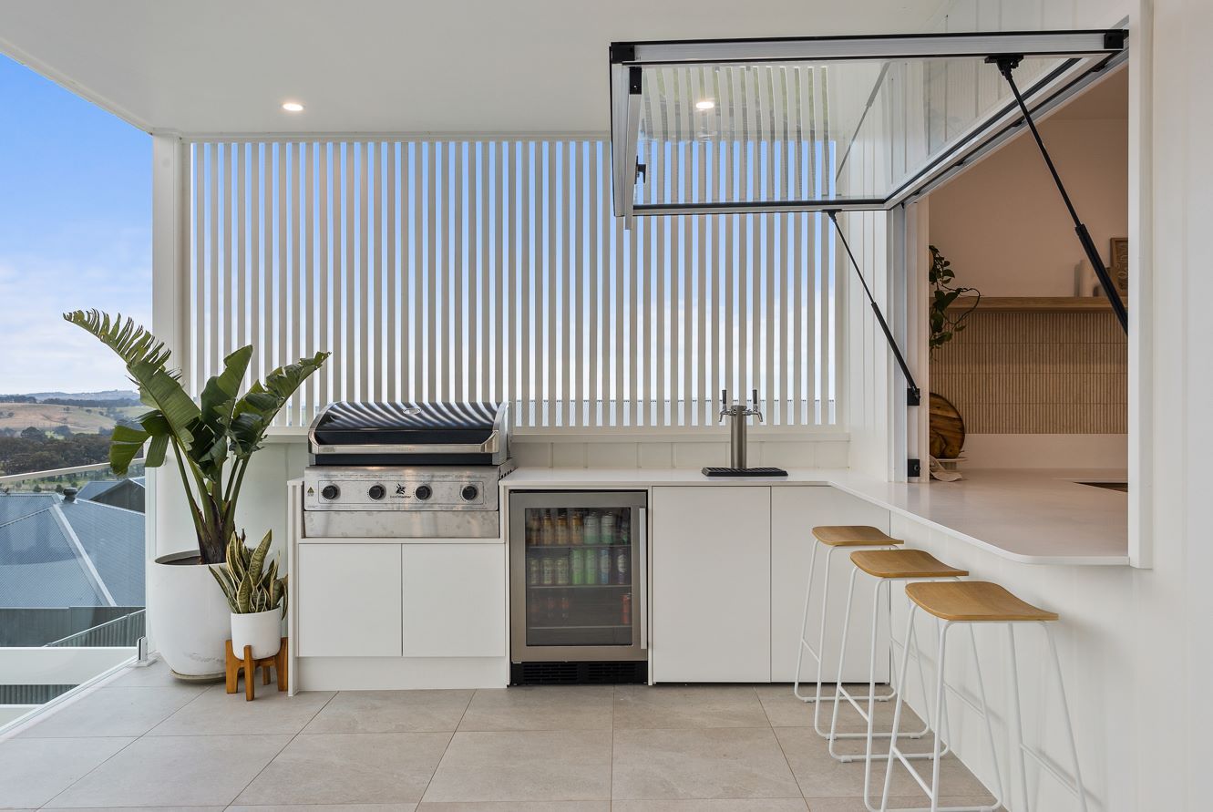 A Kitchen With a Grill and Stools and a View of the Ocean — Darko's Kitchens in Albion Park Rail, NSW