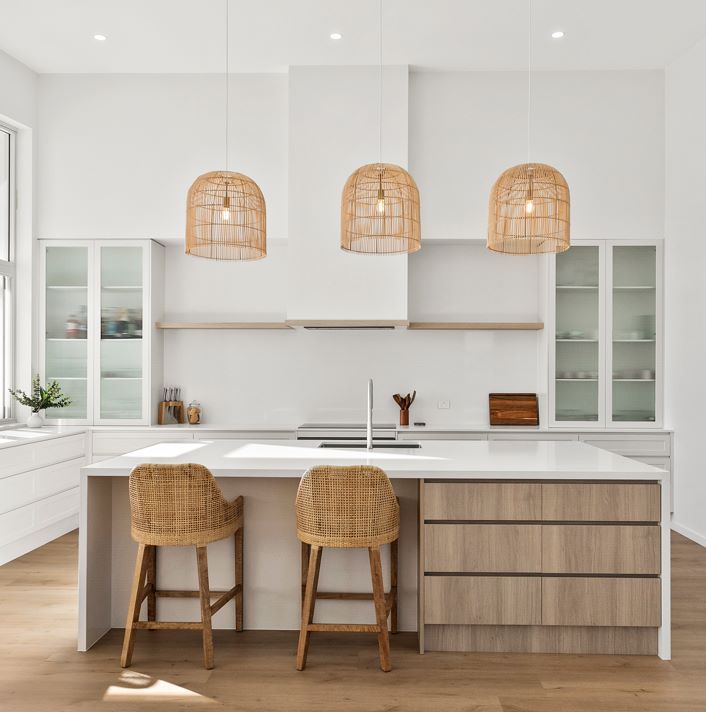 A Kitchen With a Large Island and Wicker Stools — Darko's Kitchens in Albion Park Rail, NSW