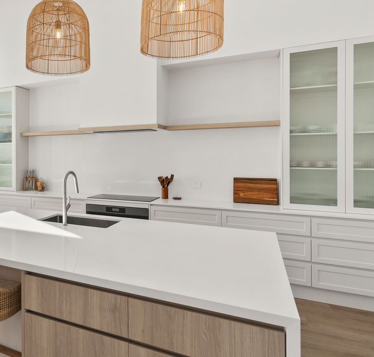 A Kitchen With White Cabinets and a Large Island in the Middle — Darko's Kitchens in Albion Park Rail, NSW