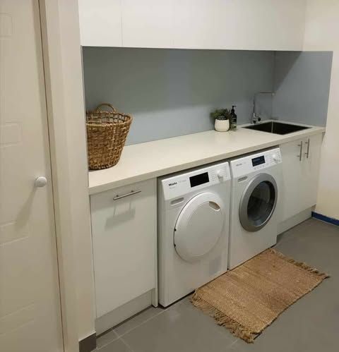 A Laundry Room With a Washer and Dryer and a Sink — Darko's Kitchens in Albion Park Rail, NSW