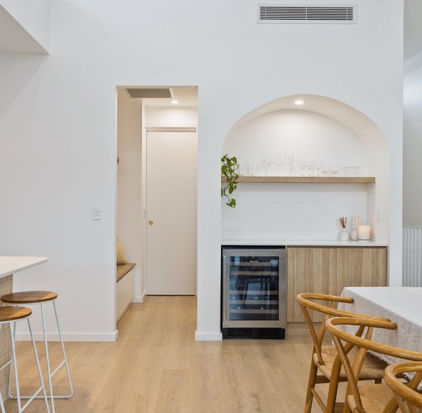 A Kitchen With Stools and a Wine Cooler — Darko's Kitchens in Albion Park Rail, NSW