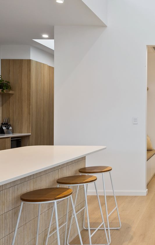 Three Bar Stools Are Sitting Next to Each Other in a Kitchen — Darko's Kitchens in Unanderra, NSW