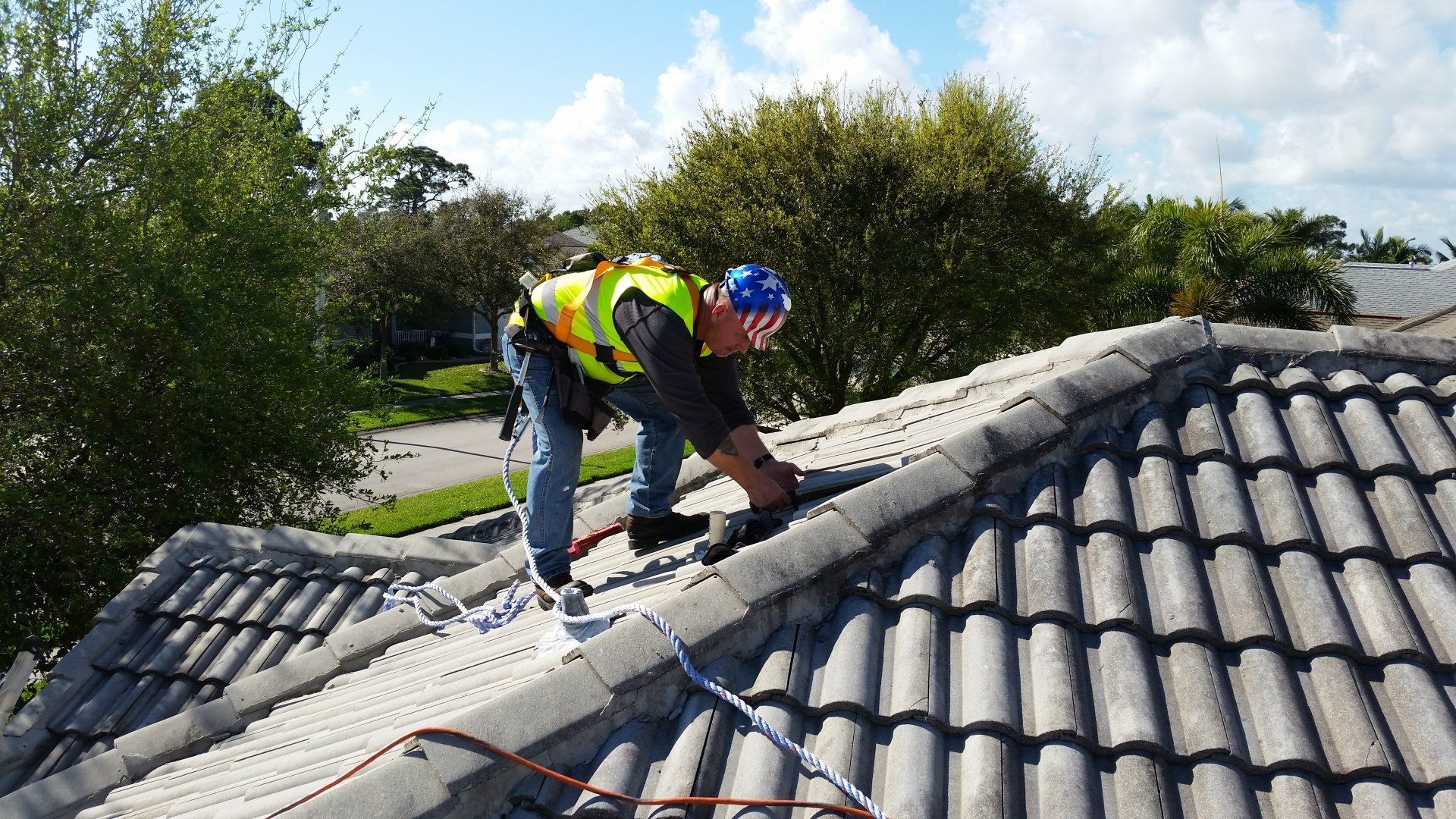 a man is working on the roof of a house .
