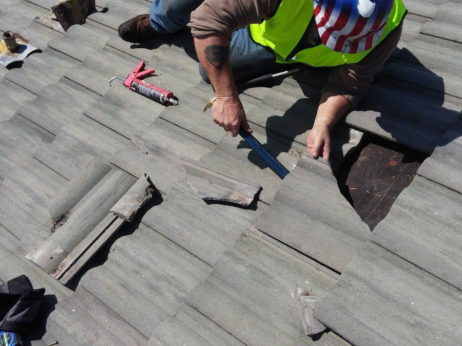 a man wearing an american flag hat is working on a roof