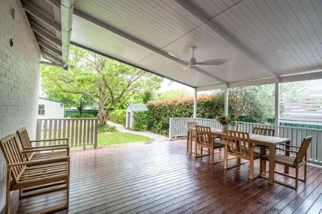 Covered Wooden Patio with Dining Table, Chairs, Ceiling Fan — Boyne Building & Renovations in Ponto, NSW