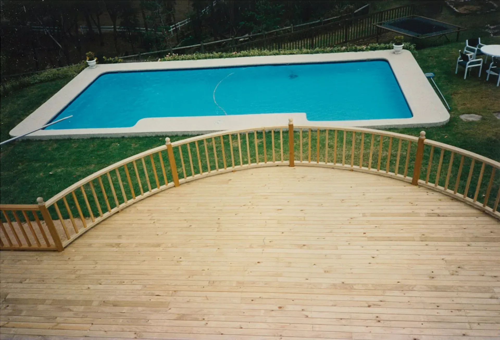 Wood Deck Overlooking a Turquoise Rectangular Pool — Boyne Building & Renovations in Ponto, NSW