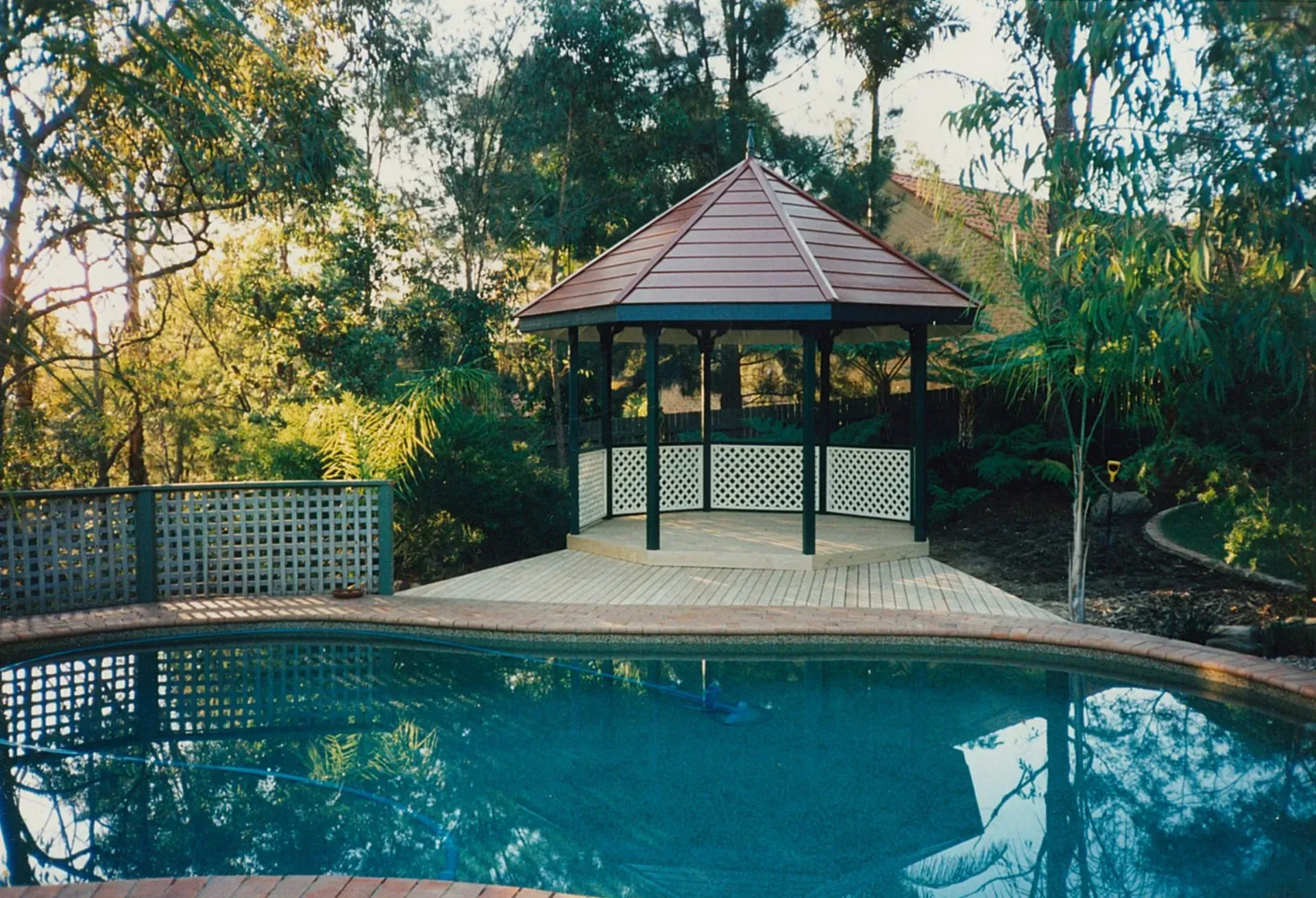 Backyard Pool with A Gazebo and Trees in Warm Sunlight — Boyne Building & Renovations in Ponto, NSW