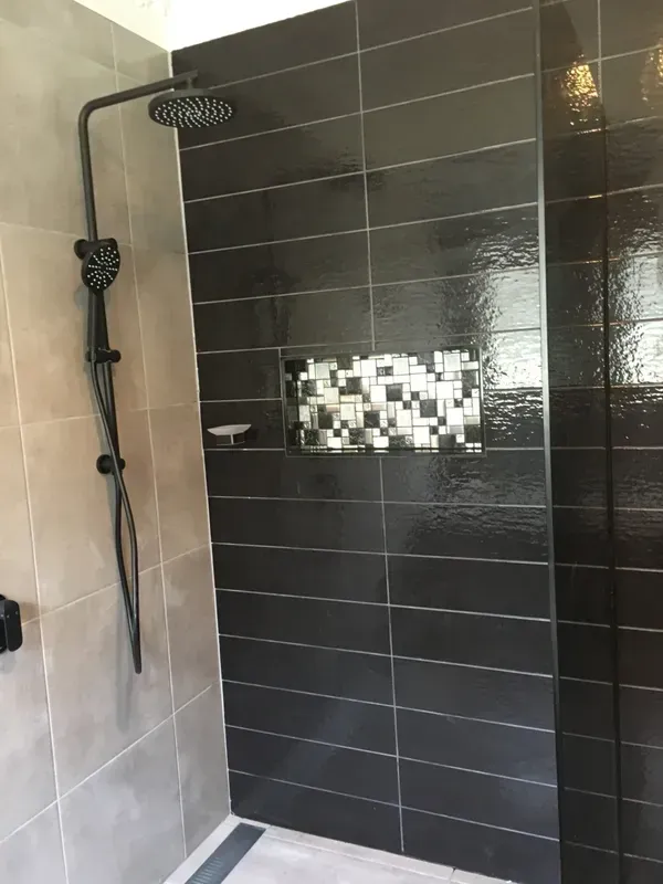 Modern Bathroom Shower with Black Tiled Wall, Rainfall Showerhead — Boyne Building & Renovations in Ponto, NSW