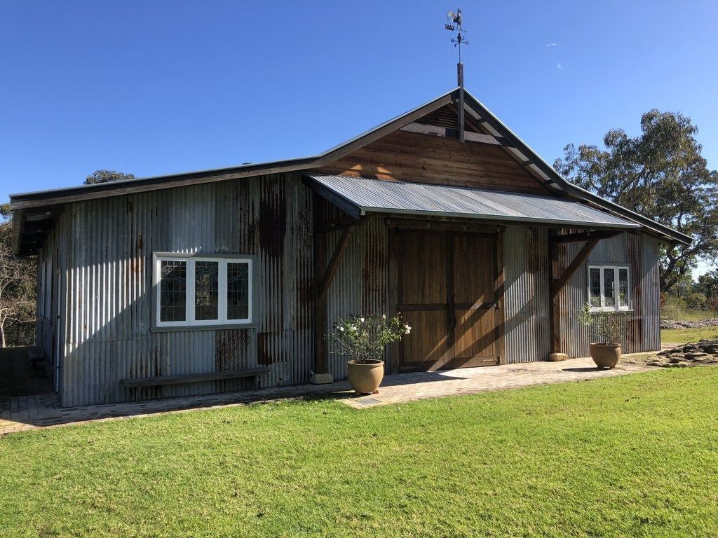 Rustic Wooden House with A Metal Roof and Porch — Boyne Building & Renovations in Ponto, NSW