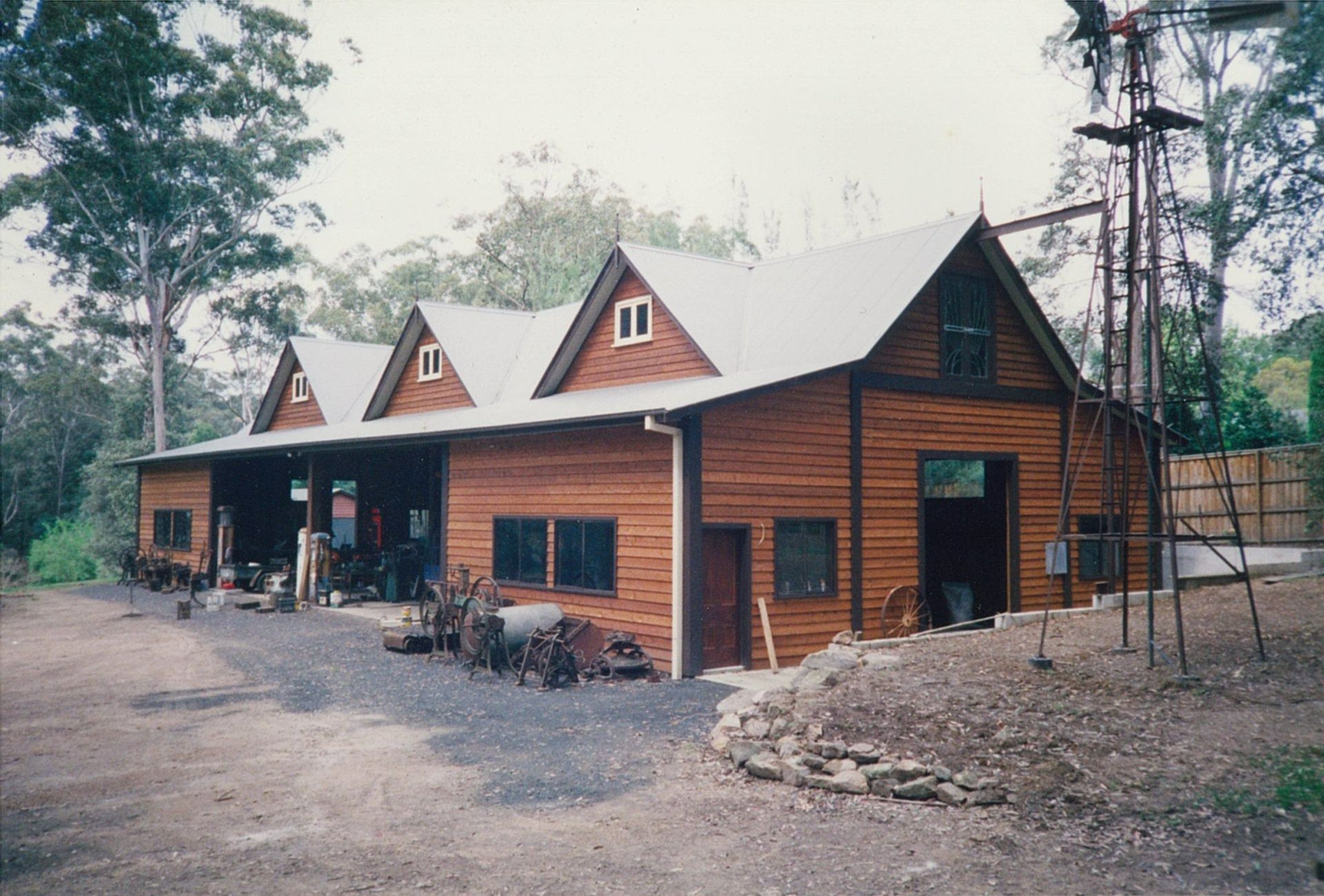 Rustic Brown Log Cabin with Three Dormer Windows in A Wooded Clearing — Boyne Building & Renovations in Ponto, NSW