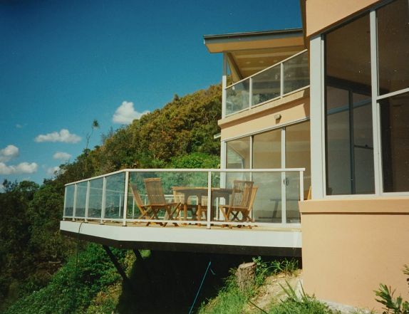 Modern House Balcony with Glass Railing — Boyne Building & Renovations in Ponto, NSW