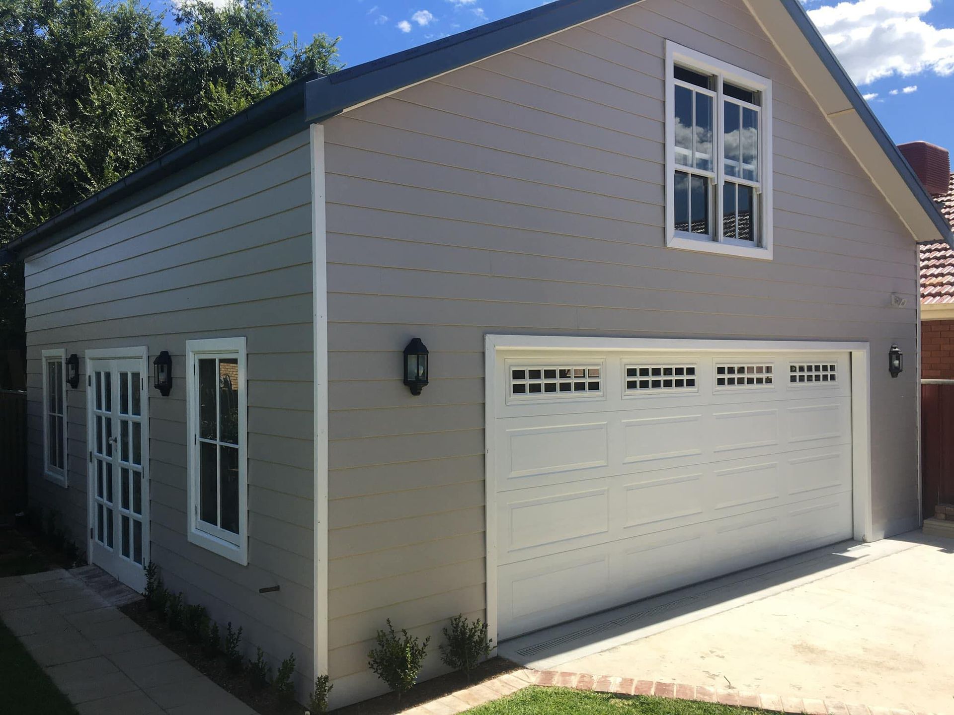 Gray Two-Car Garage with White Doors and Windows — Boyne Building & Renovations in Ponto, NSW