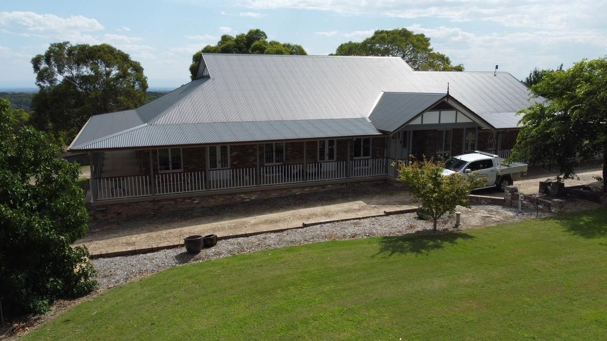 Large Gray-Roofed House With a Wraparound Porch — Boyne Building & Renovations in Ponto, NSW