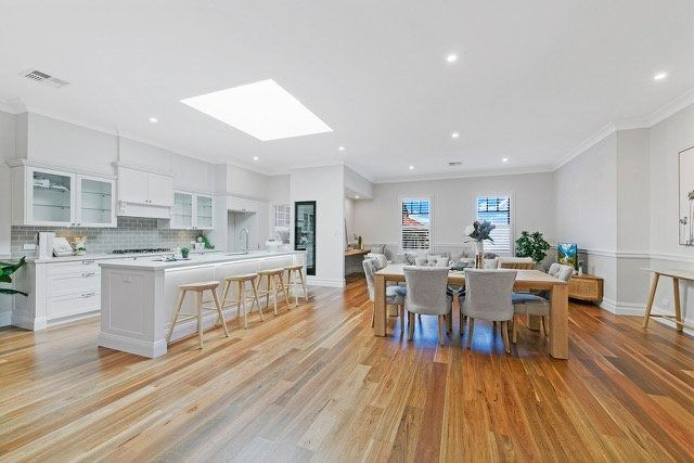 Bright Open-Plan Kitchen and Dining Room with White Cabinets — Boyne Building & Renovations in Ponto, NSW