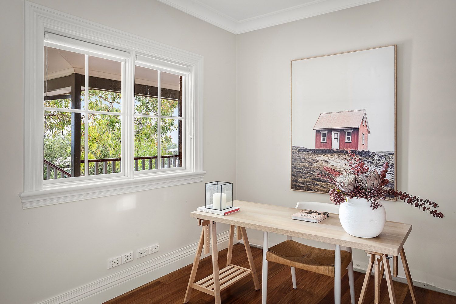 Bright Home Office Nook With a Wooden Desk, Stool, Framed Art, and a Window — Boyne Building & Renovations in Ponto, NSW