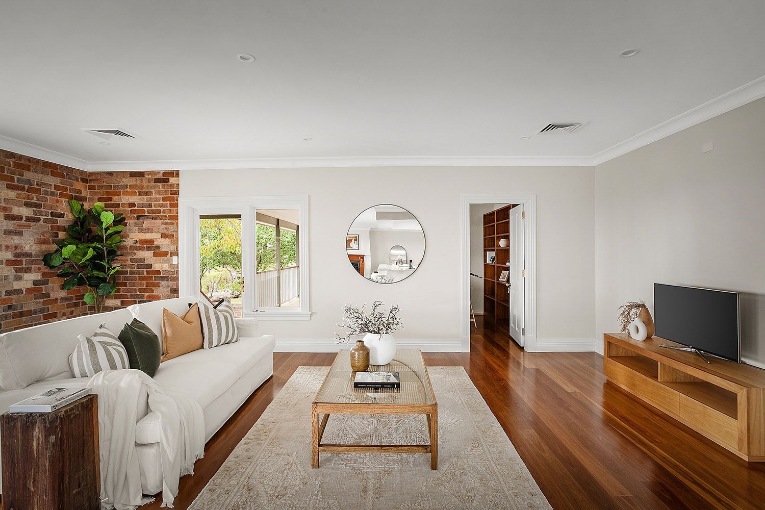 Bright Living Room With White Sofa, Wooden Coffee Table and TV Console — Boyne Building & Renovations in Ponto, NSW