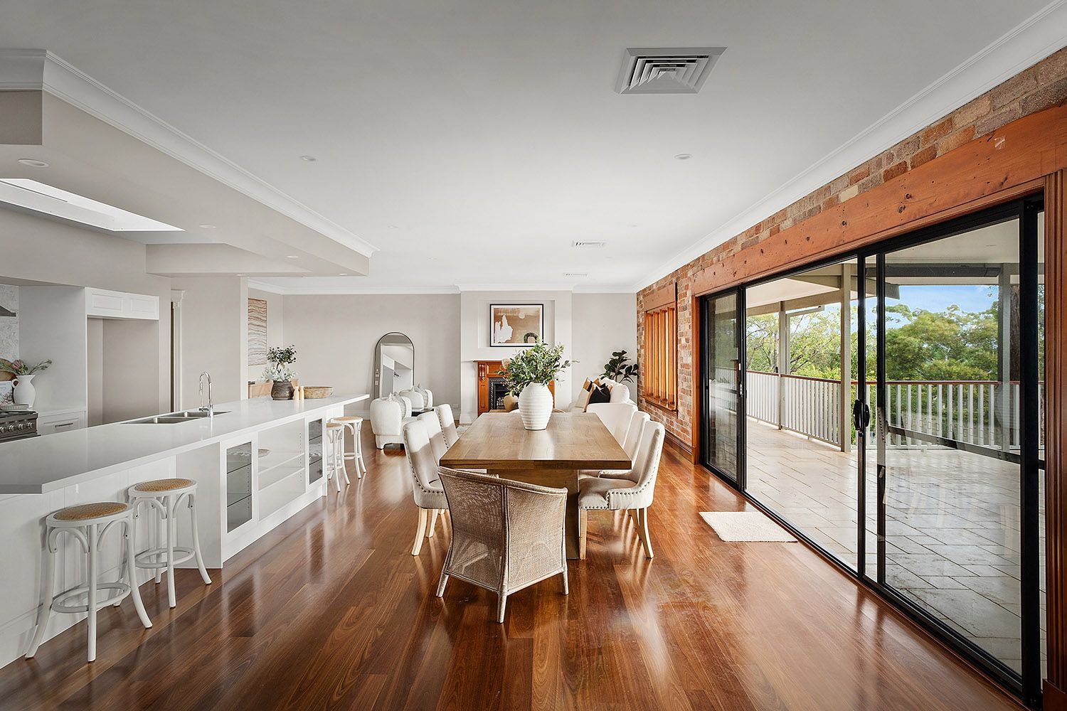 Bright Open-plan Dining Room With Wooden Table — Boyne Building & Renovations in Ponto, NSW