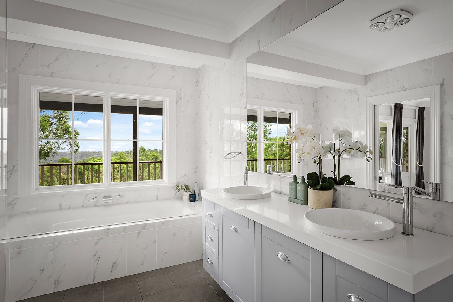 Bright White Bathroom With Double Vanity, Mirrors, and a Window — Boyne Building & Renovations in Ponto, NSW