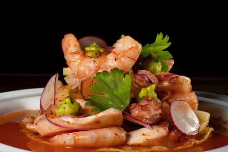 Shrimp and noodle salad with red onions, cilantro, and sauce in a bowl