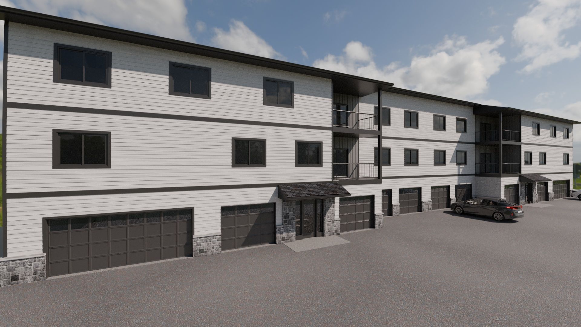 Modern white three-story apartment building with garage doors and parked cars on a paved lot.