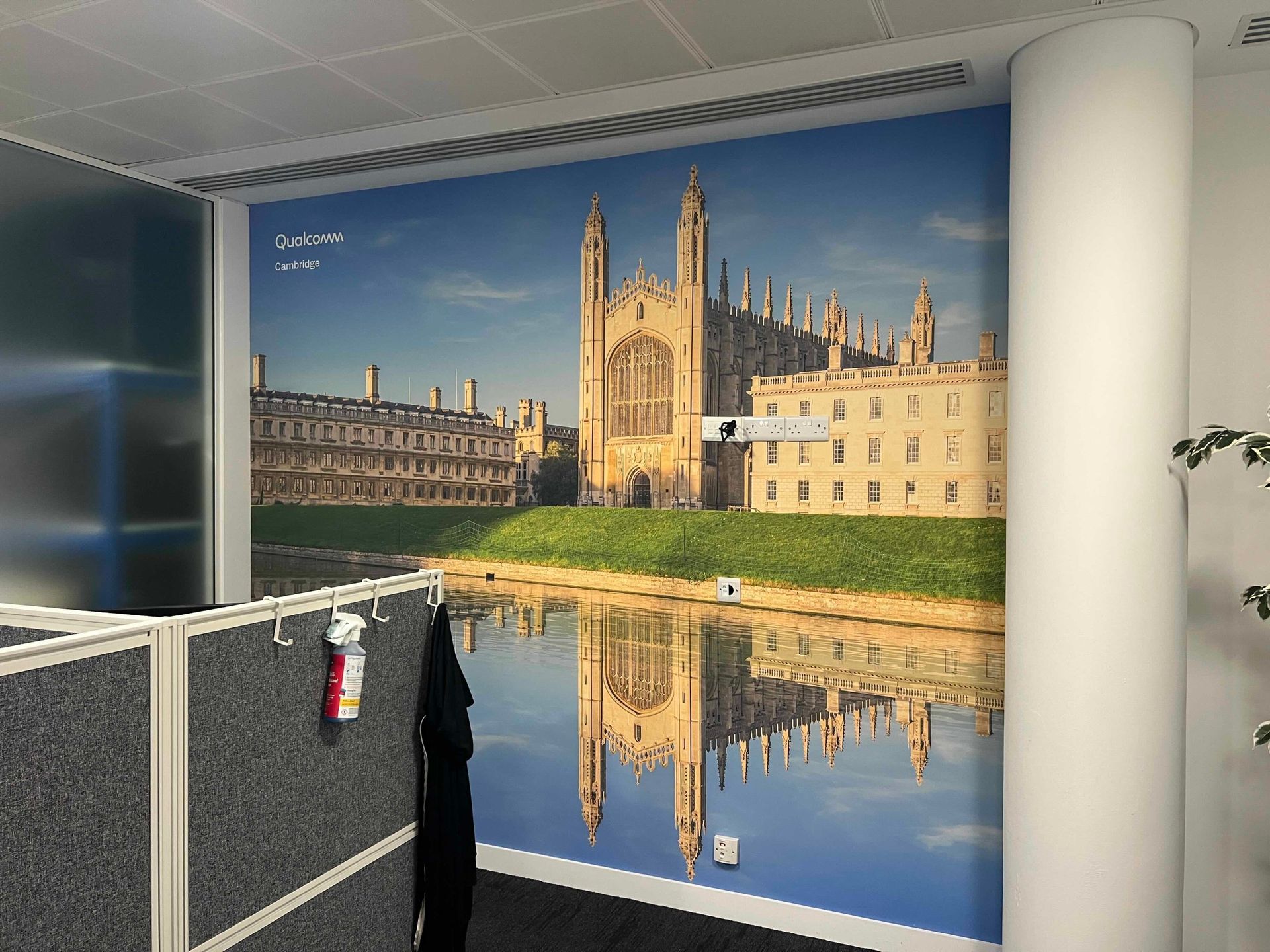 Printed wall art of a Cambridge college used as a video conference backdrop
