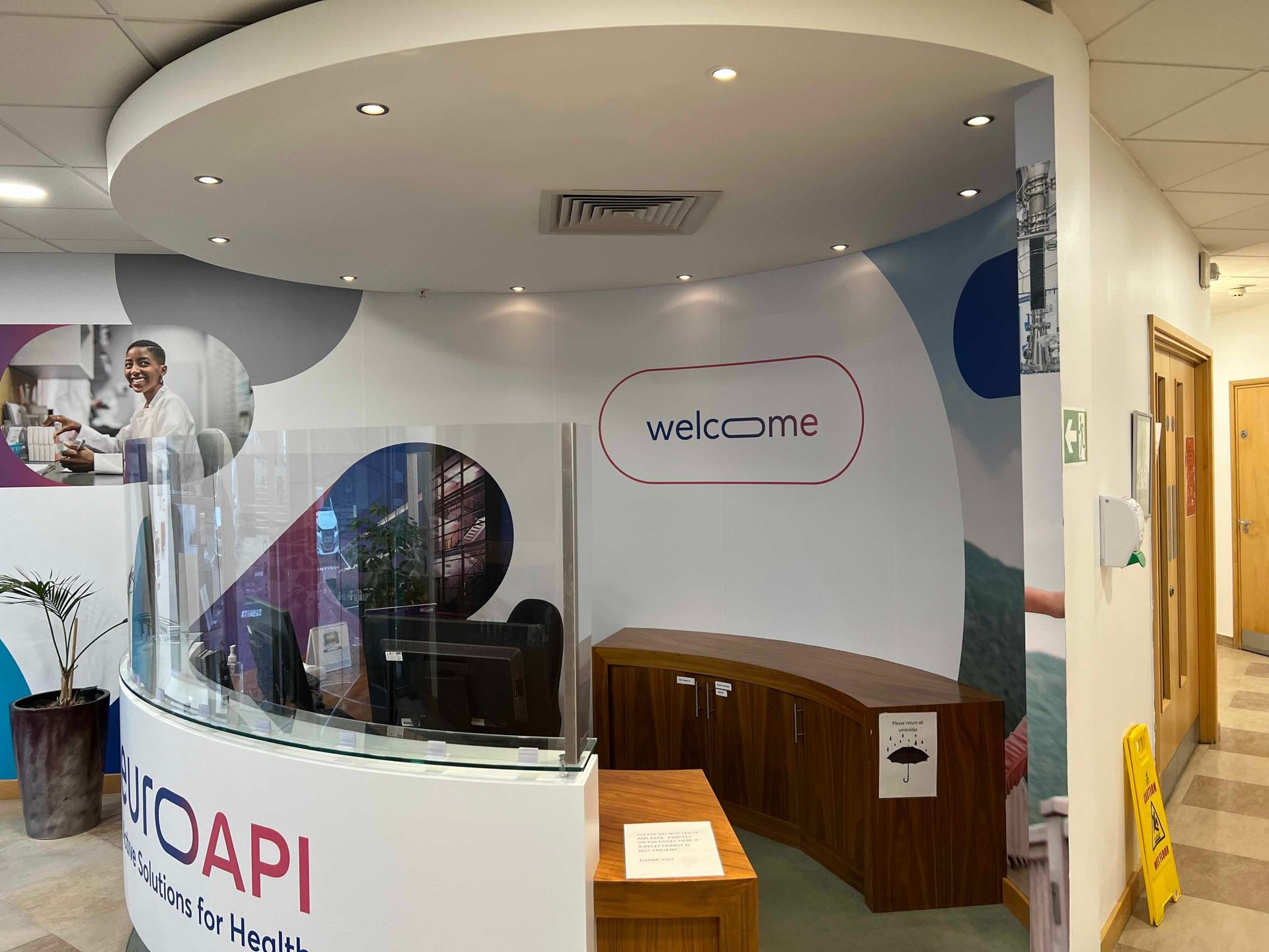 Reception desk with printed wall graphics, desk front and protective screen